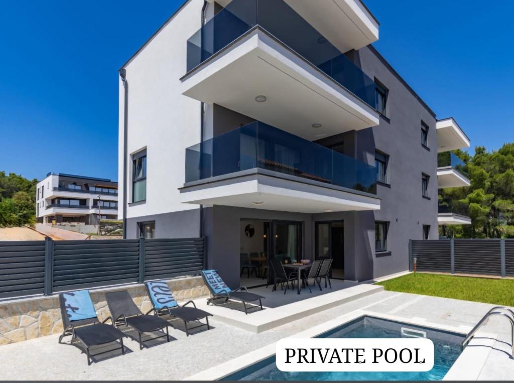 a villa with a swimming pool and a private pool at Apartment Island Krk Queen 1 in Krk