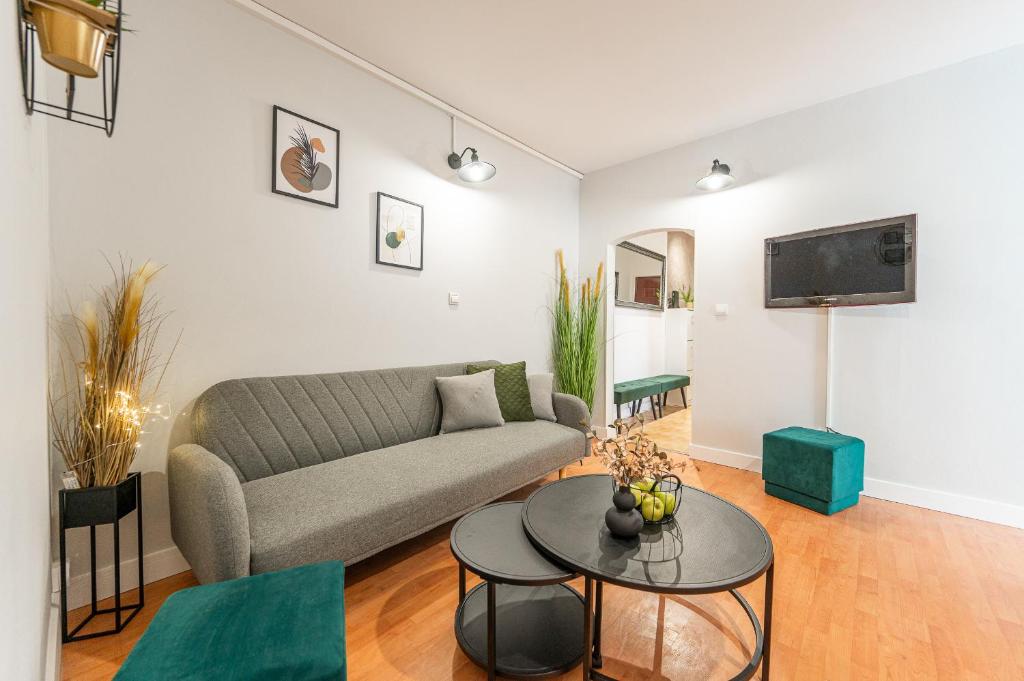 a living room with a couch and a table at City Apartment near Aupark in Košice