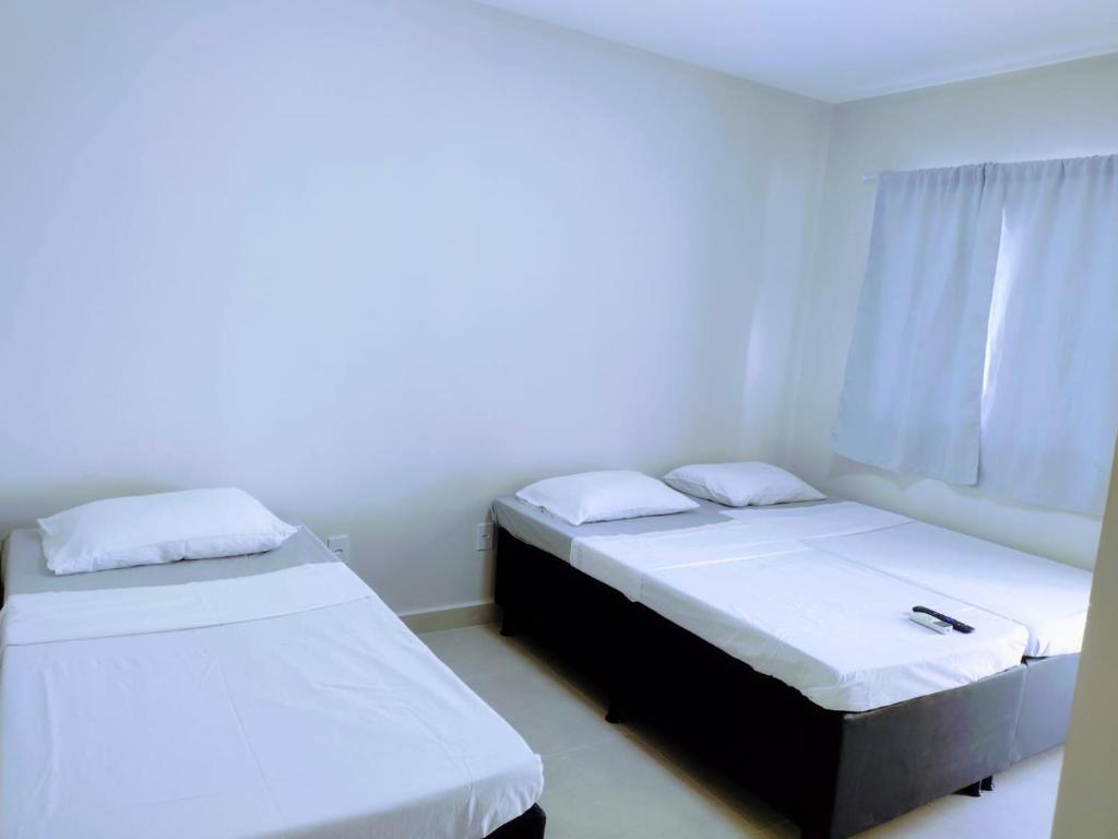 Ένα ή περισσότερα κρεβάτια σε δωμάτιο στο Suítes Praia e Sol