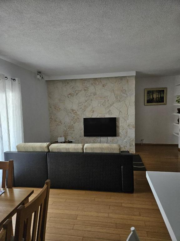a living room with a couch and a flat screen tv at Klara in Vodice