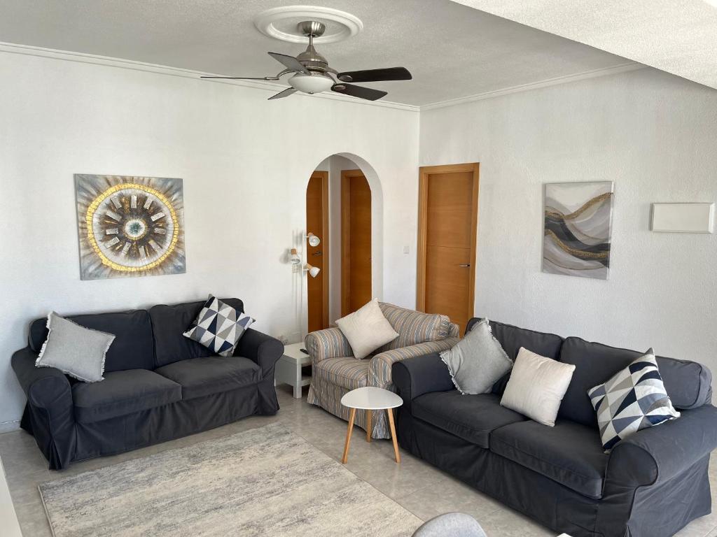a living room with two couches and a ceiling fan at La Marquesa Golf 3 bedroom Detached Villa in Ciudad Quesada