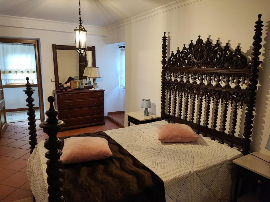 a bedroom with a large bed with two pillows on it at Casa da Avó in Cetos
