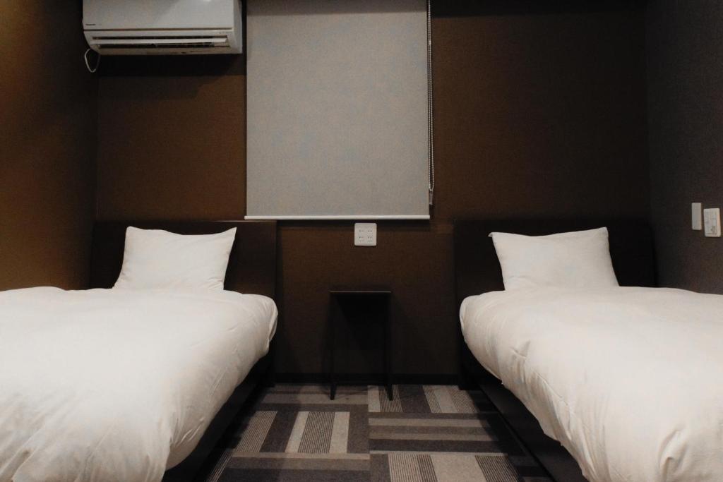 Postel nebo postele na pokoji v ubytování Stay HOTEL