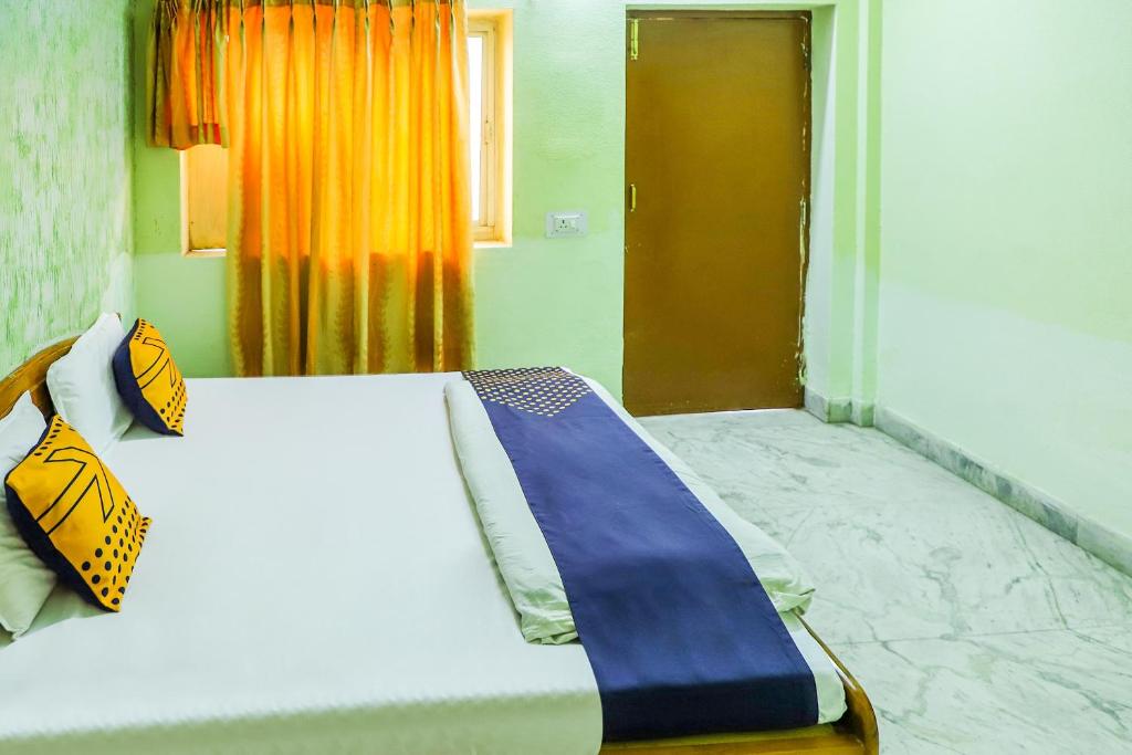 a bedroom with a bed with ties on it at SPOT ON Nanki Palace in Ajmer
