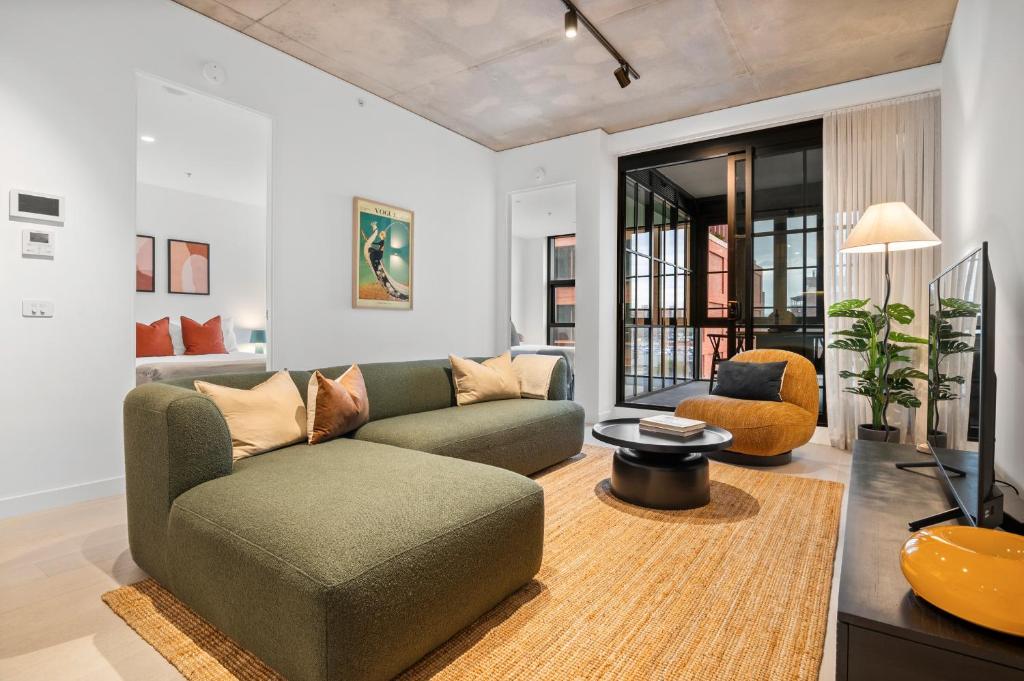 a living room with a couch and a tv at Modern, Luxury Retreat with Gym and Pool in Melbourne