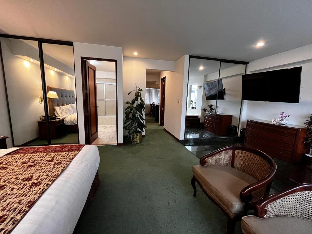 a hotel room with a bed and a large mirror at Hotel Boulevard in Lima