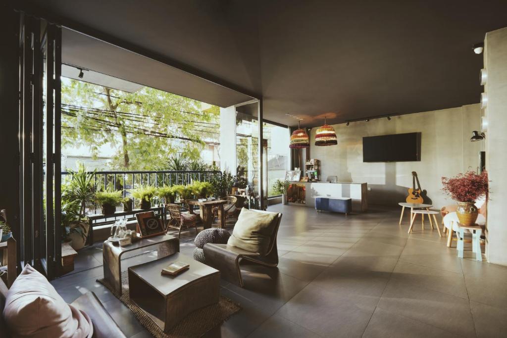 a living room filled with furniture and a large window at La Maison Des Délices in Danang