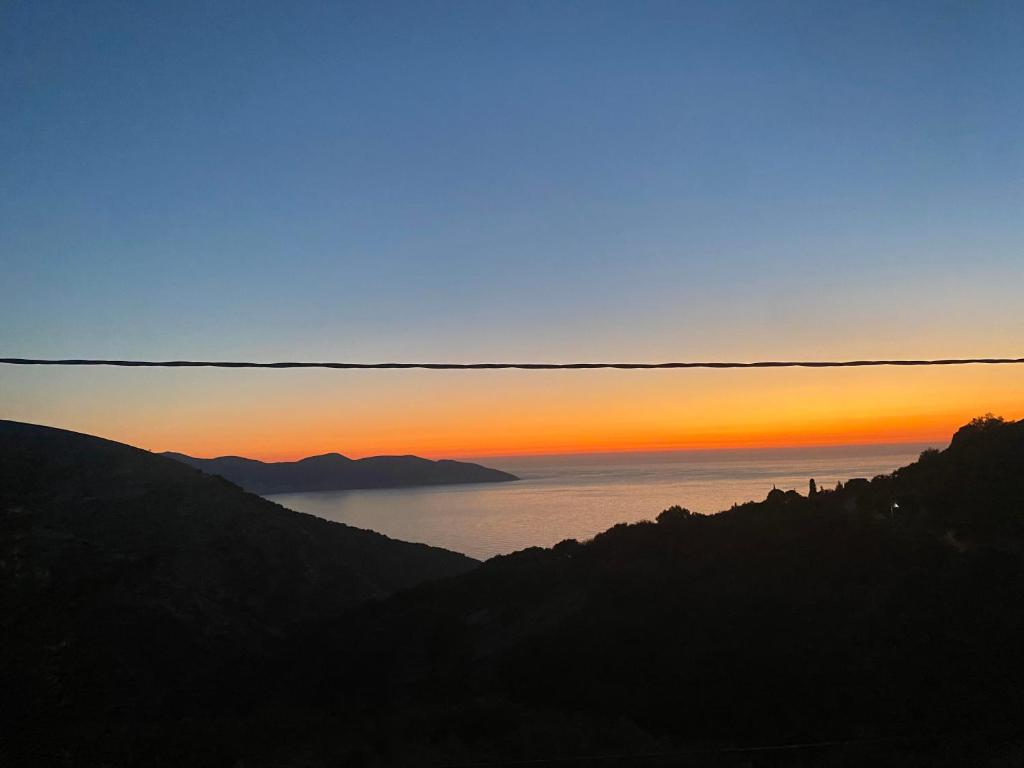 a view of the ocean at sunset at Stefania's house in Agia Effimia