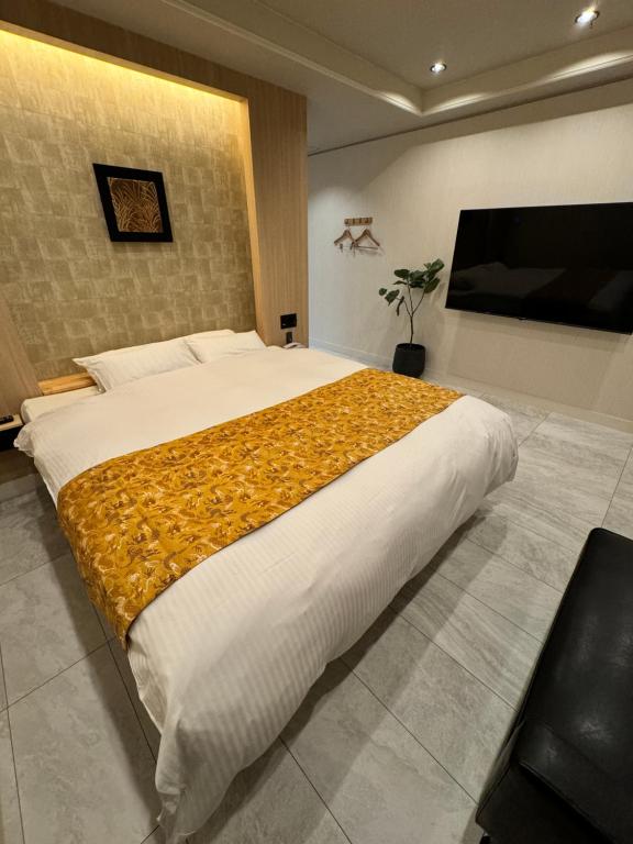 Postel nebo postele na pokoji v ubytování Hotel Be-zen shimanouchi