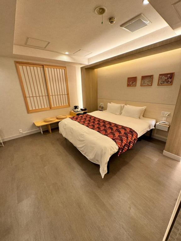 Postel nebo postele na pokoji v ubytování Hotel Be-zen shimanouchi