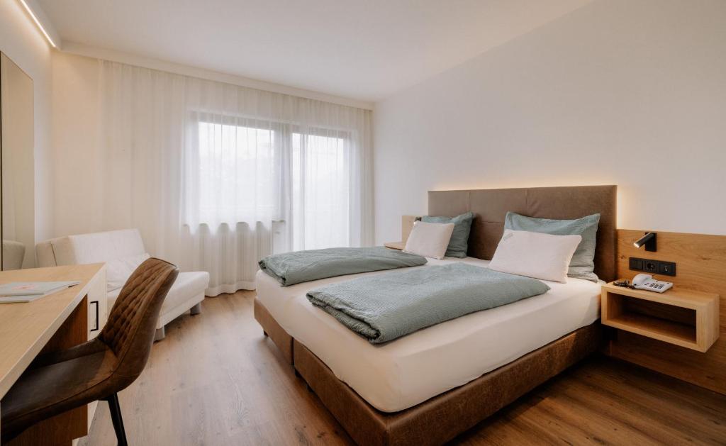 Postel nebo postele na pokoji v ubytování Garni-Hotel Farmerhof