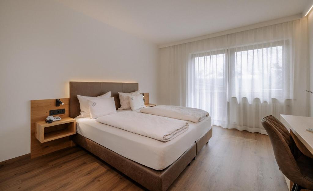 Postel nebo postele na pokoji v ubytování Garni-Hotel Farmerhof