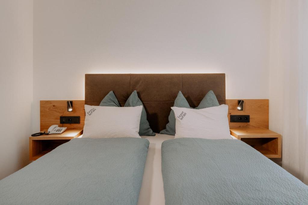 Postel nebo postele na pokoji v ubytování Garni-Hotel Farmerhof