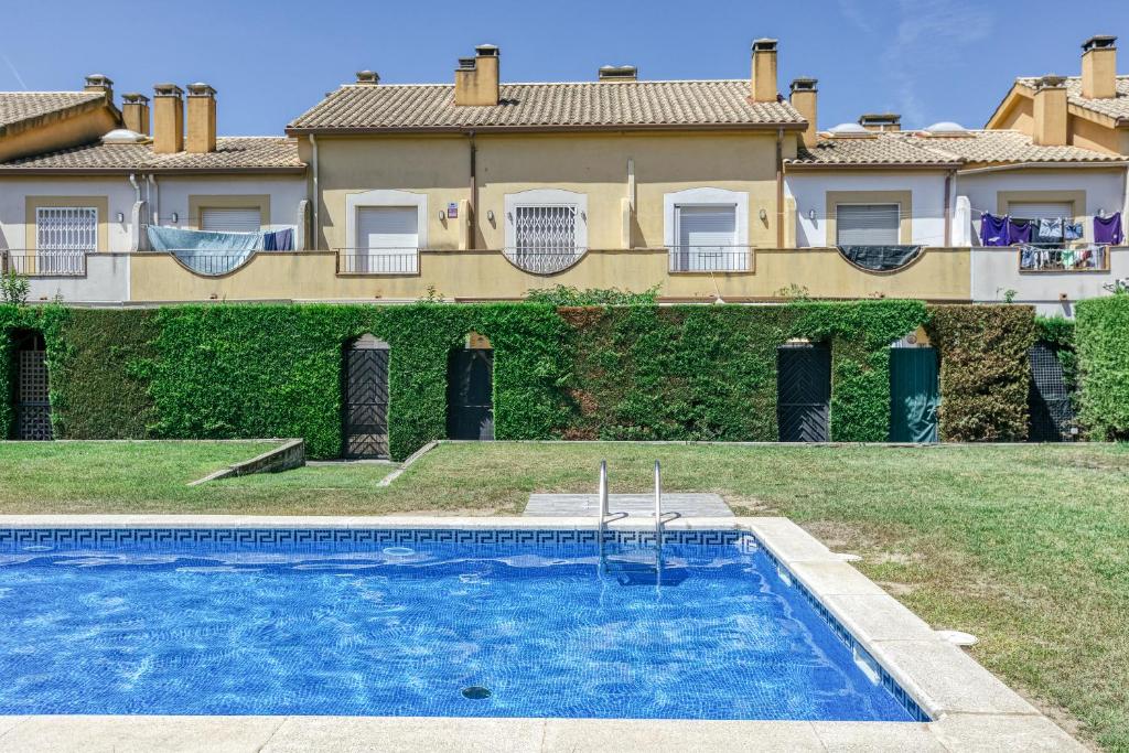 a villa with a swimming pool in front of a house at Les Medes in L'Estartit