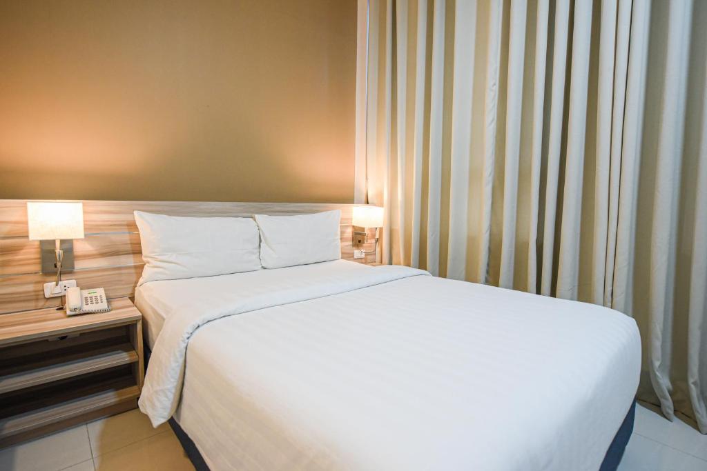 Postel nebo postele na pokoji v ubytování Figtree Hotel