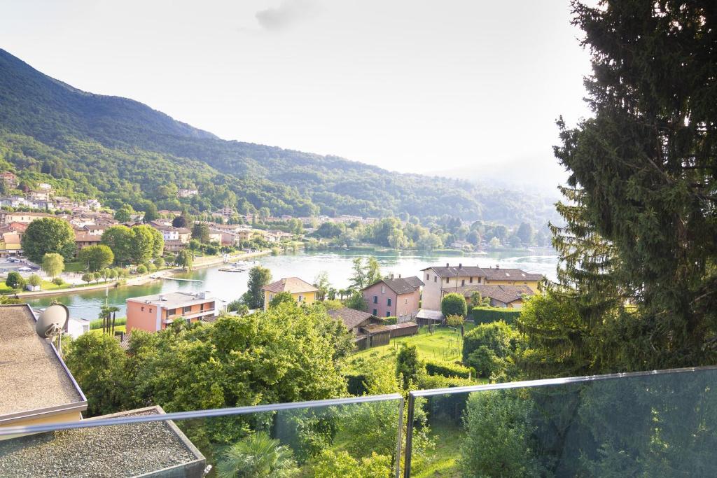 a view of a river with houses and a town at Apartment Design - Terrazzo, vista lago mozzafiato in Caslano