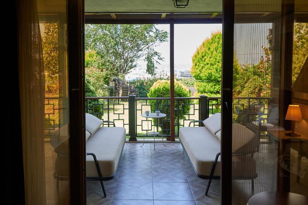 a balcony with white chairs and a view of the city at Phellos Suites Boutique Hotel in Şile