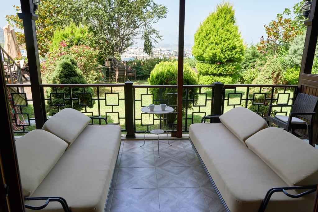 a balcony with white furniture and a view of the city at Phellos Suites Boutique Hotel in Şile
