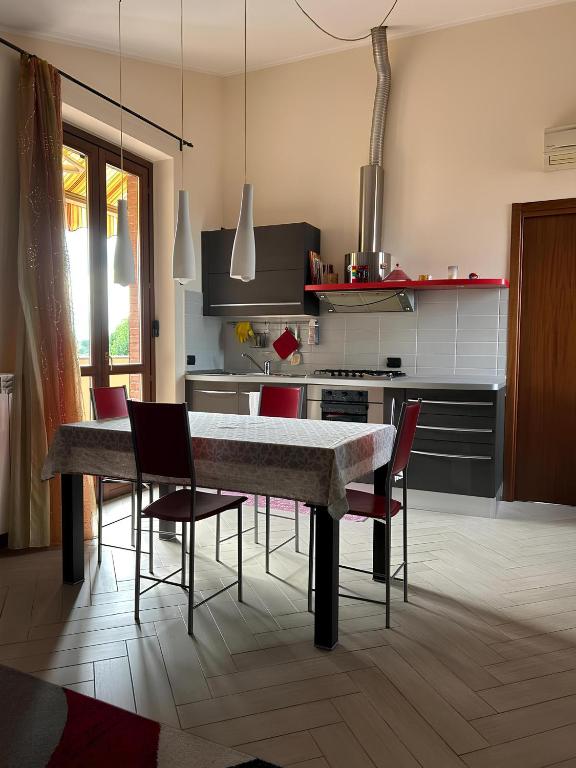 a kitchen with a table and chairs in a room at Appartamento Antony's House in Limbiate