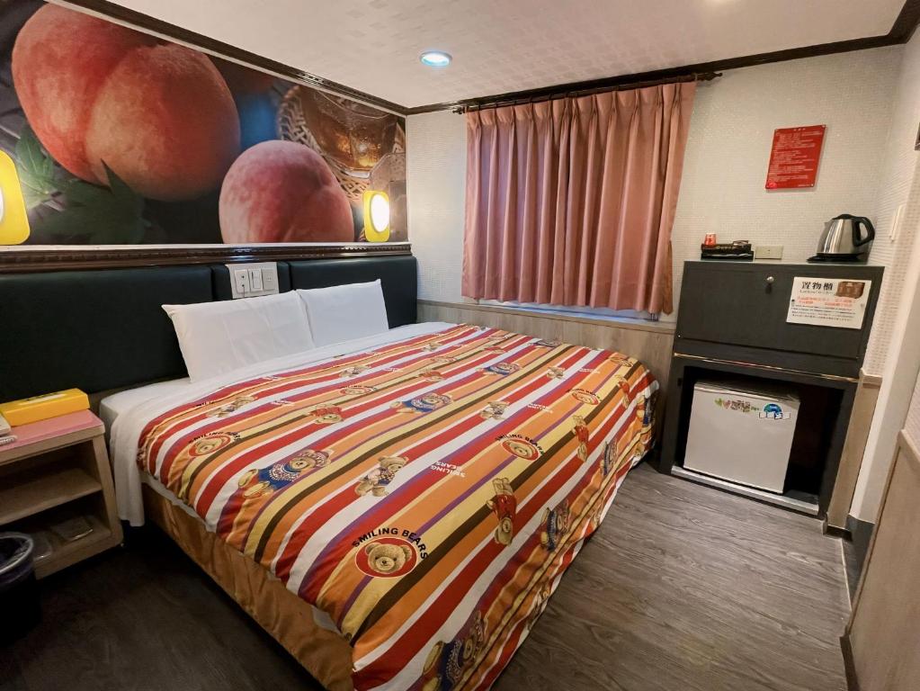 a hotel room with a bed and a painting on the wall at Dealer Hotel in Taipei