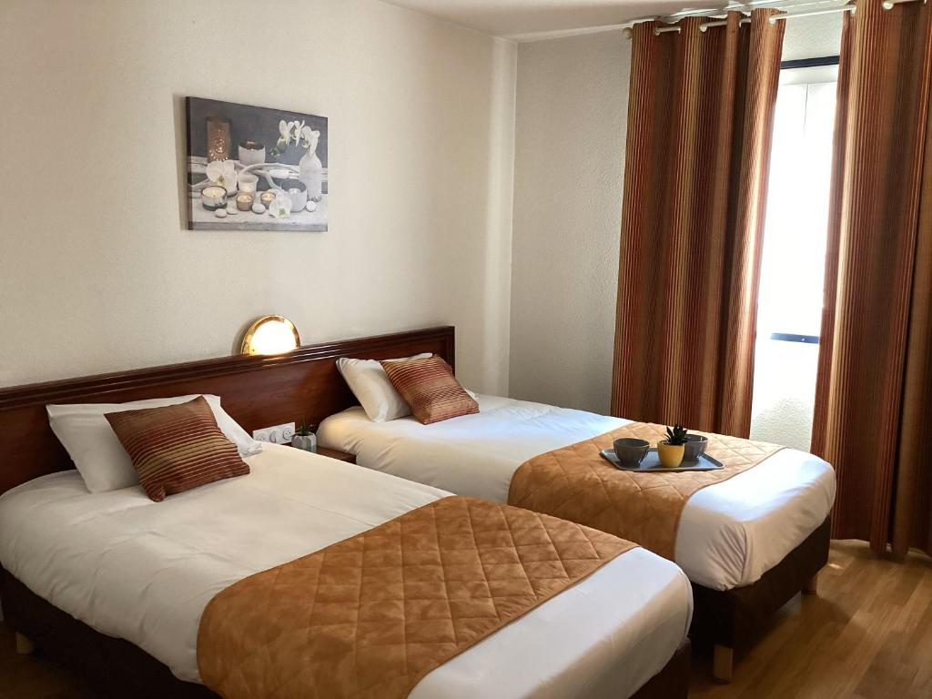 Postel nebo postele na pokoji v ubytování Hôtel Angelic