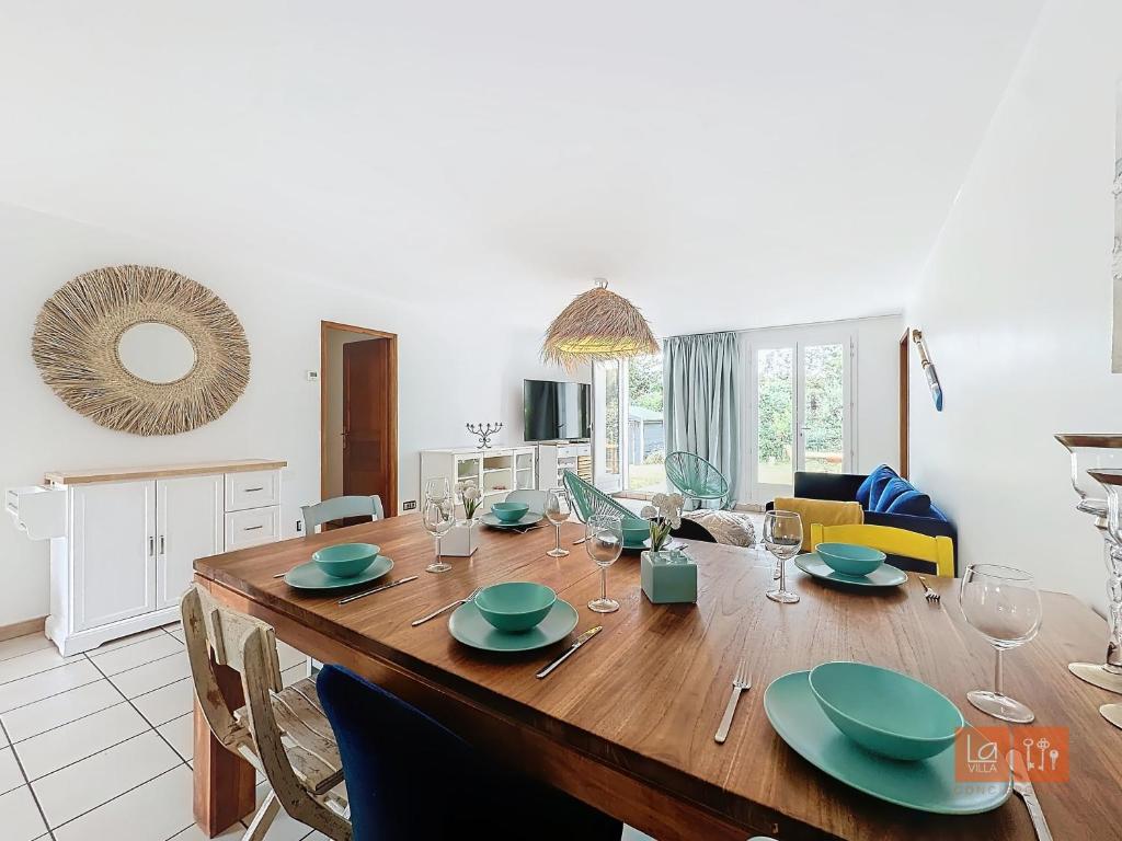 - une salle à manger et un salon avec une table en bois dans l'établissement Au Ptit Bouchon Villa Golf, à Wimereux