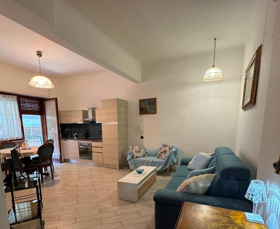 a living room with a blue couch and a table at CASA LORY Balduina in Rome
