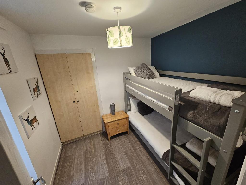 a bedroom with two bunk beds and a door at Mary Street Standard Apartment in Galway
