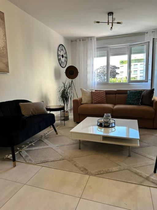 un salon avec un canapé et une table basse dans l'établissement Spacieux Appartement de 73 m2 en plein centre-ville d'Evian avec 2 chambres, à Évian-les-Bains