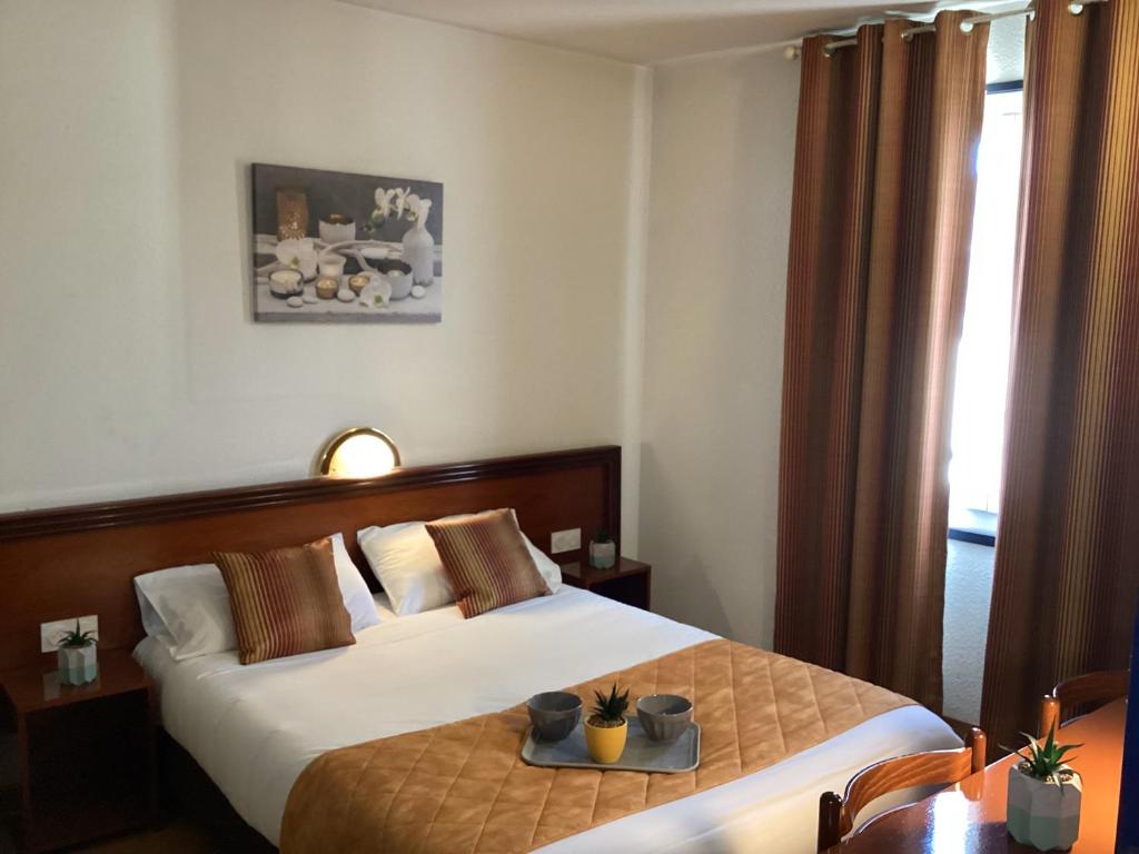 Postel nebo postele na pokoji v ubytování Hôtel Angelic