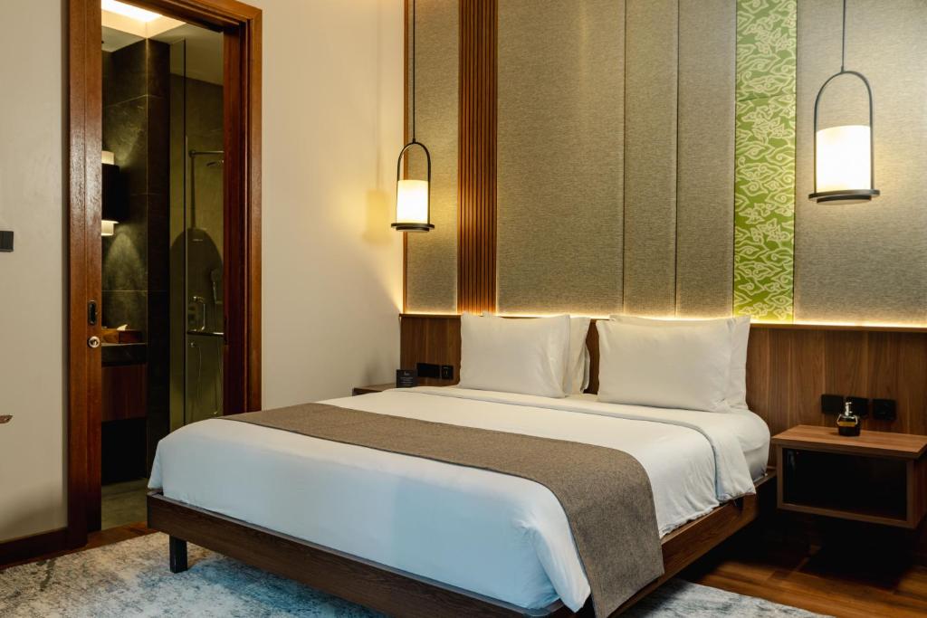 Postel nebo postele na pokoji v ubytování Plataran Puncak Residences