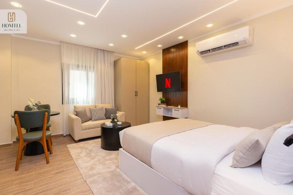 Postel nebo postele na pokoji v ubytování Homtel Residence AUC
