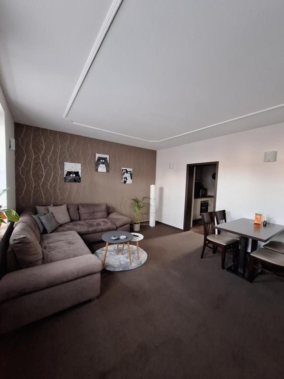 a living room with a couch and a table at Ferienapartment Lilo in Eisenhüttenstadt