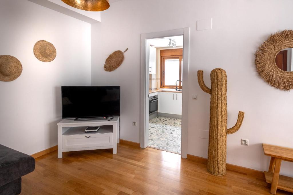 Televízia a/alebo spoločenská miestnosť v ubytovaní Agua MOANA SUITE