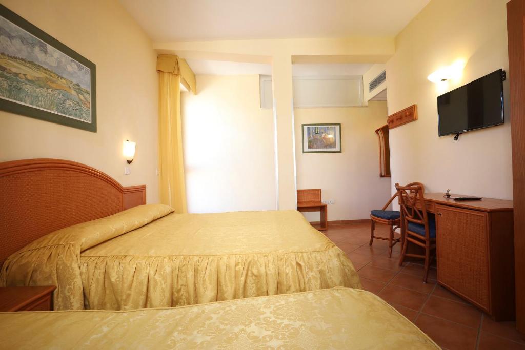Posteľ alebo postele v izbe v ubytovaní Hotel Katy