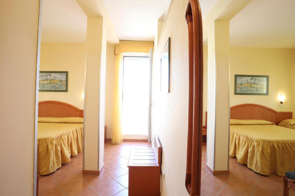 Posteľ alebo postele v izbe v ubytovaní Hotel Katy