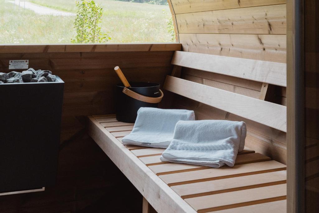 a sauna with two towels sitting on a wooden deck at Apartments Hofmann in Prateria