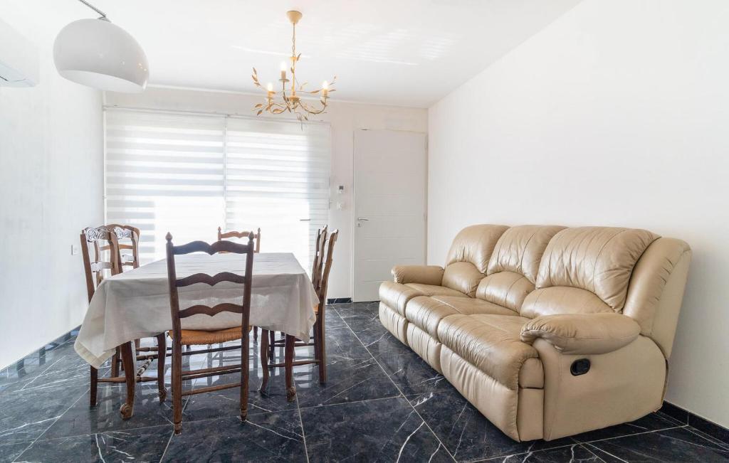 a living room with a couch and a table at 2 Bedroom Nice Home In Chateaurenard in Châteaurenard