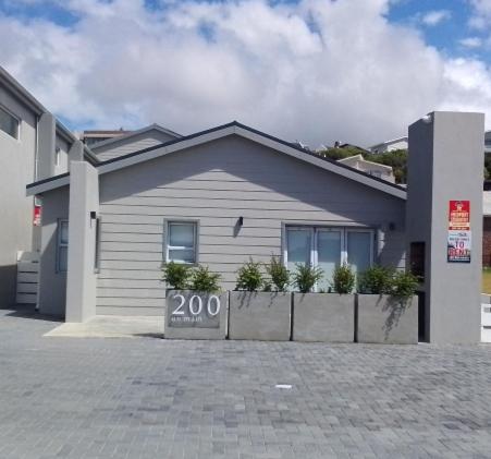 a house with a sign in front of it at Mya in Agulhas