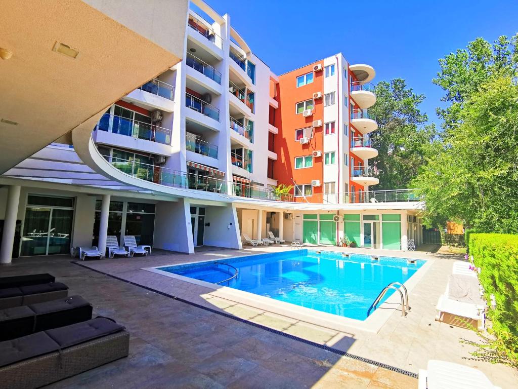 a swimming pool in front of a building at Luisa Lux Apartment - Sat Vacanta in Mamaia