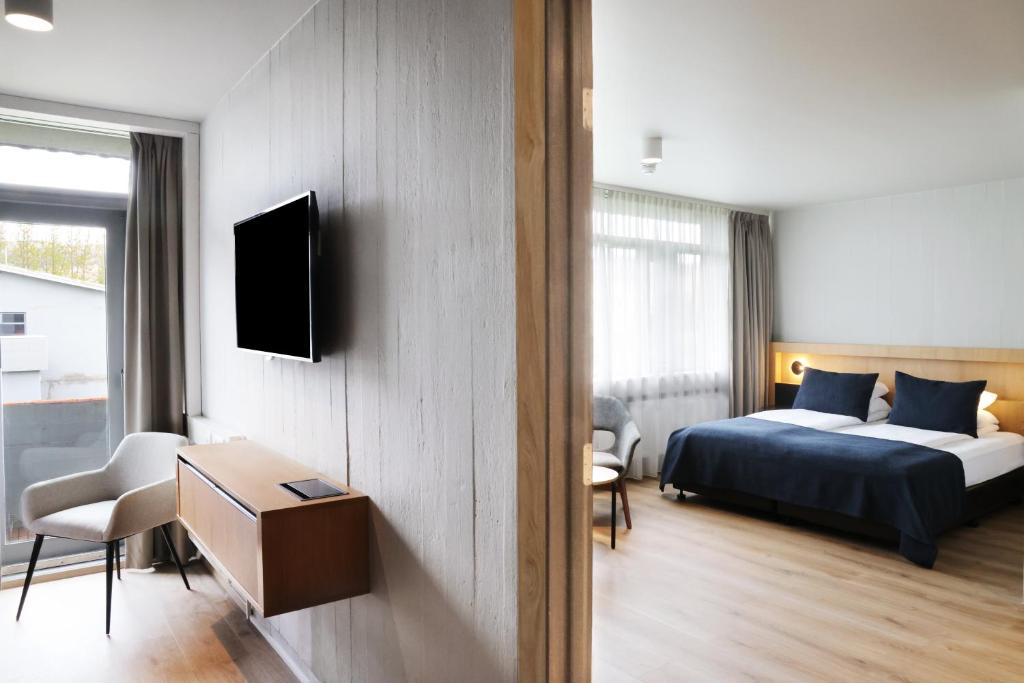 Postel nebo postele na pokoji v ubytování Fosshotel Reykholt