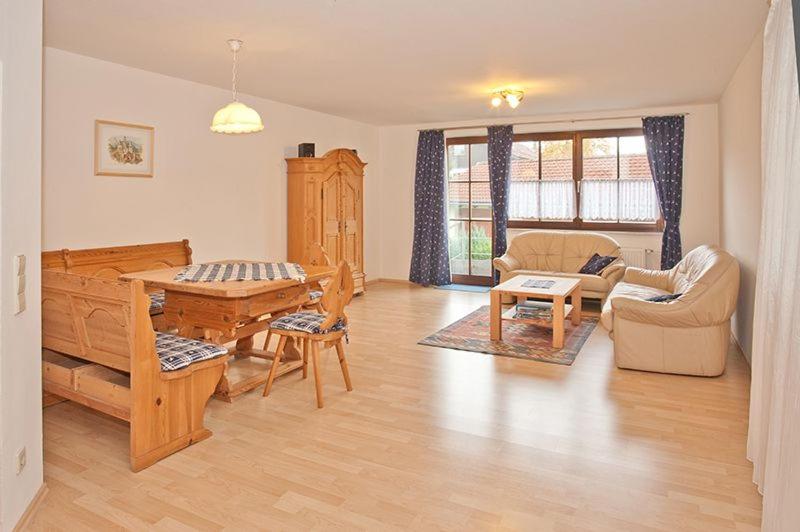 a living room filled with furniture and a table at Ferienwohnung Birkenstraße Nesselwang 9 in Nesselwang