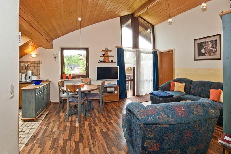 a living room with a couch and a table and a kitchen at Ferienwohnung Promenadenweg Nesselwang 14-8 in Nesselwang