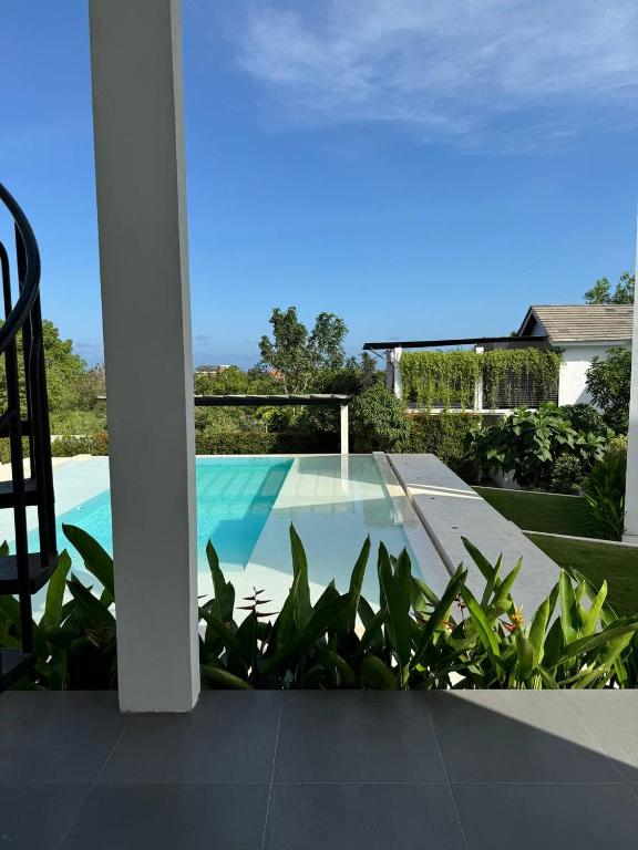 a view of a swimming pool from the balcony of a house at Villa Valeria in Ungasan