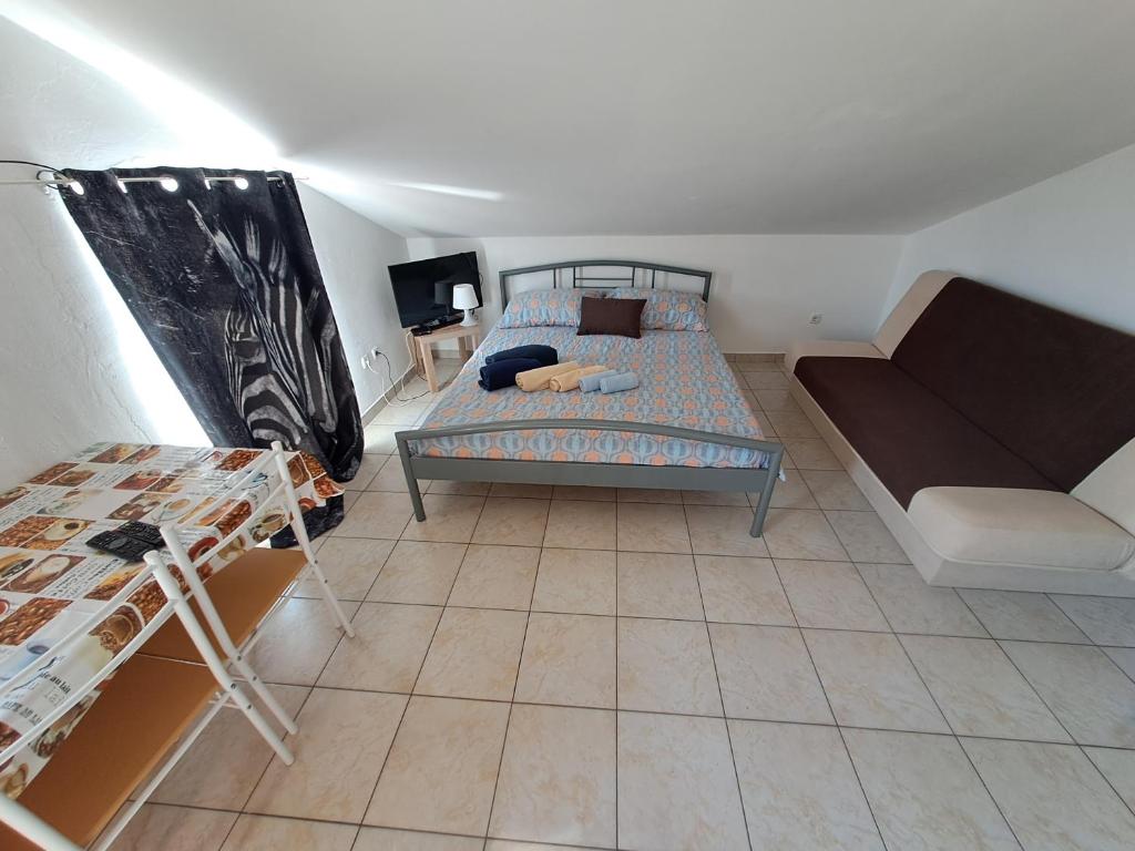 a small room with a bed and a couch at Dejan apartment4-Top centar in Pula