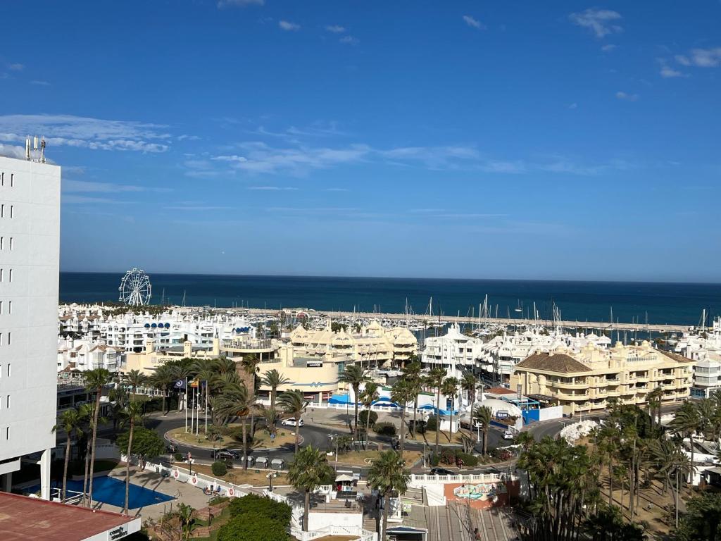 a view of a city with the ocean in the background at Apartment Puerto Marina - First Line Beach - Benalmadena - Málaga in Benalmádena