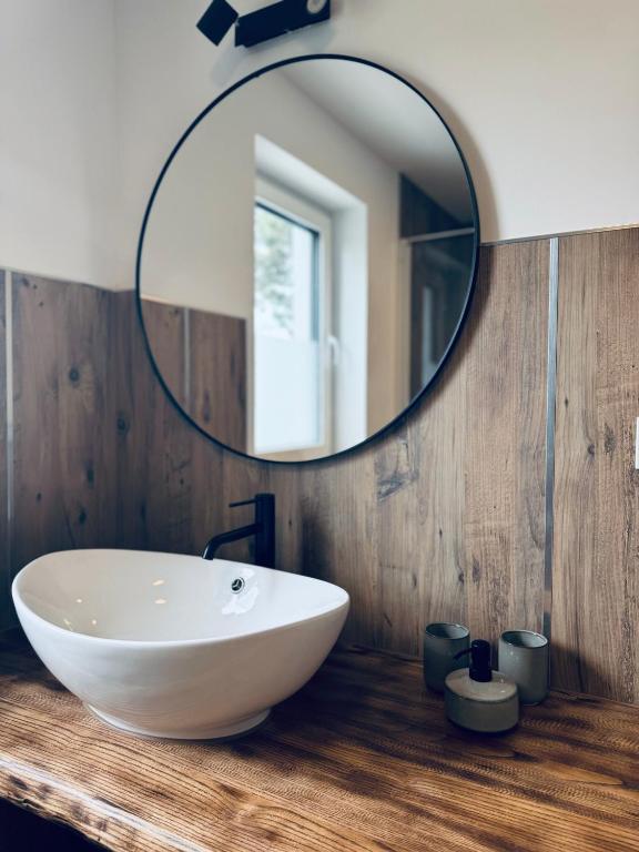 a bathroom with a white sink and a mirror at Ganzes Tiny House "Thüringer Ruhe" mit großem Garten nahe Rennsteig in Laucha