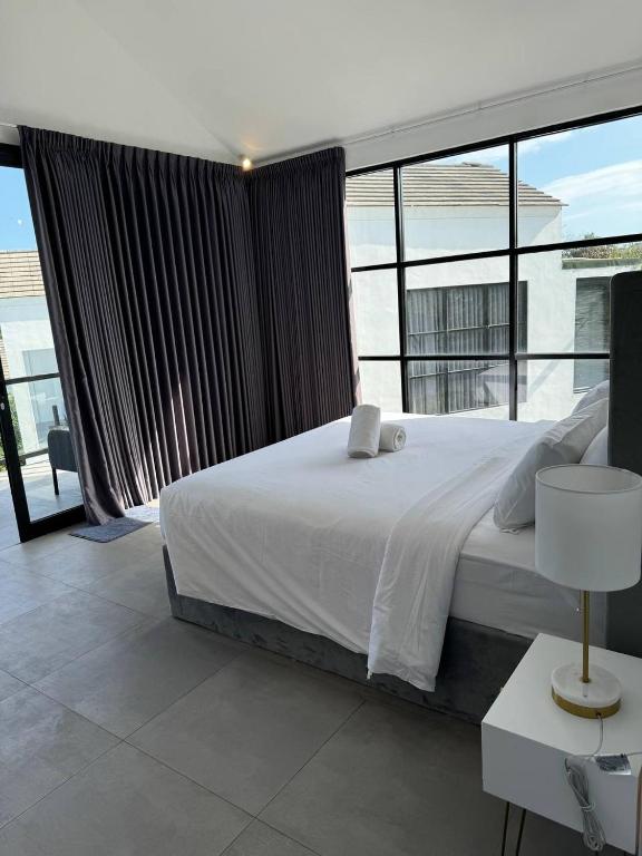 a bedroom with a large bed and a large window at Villa Valeria in Ungasan