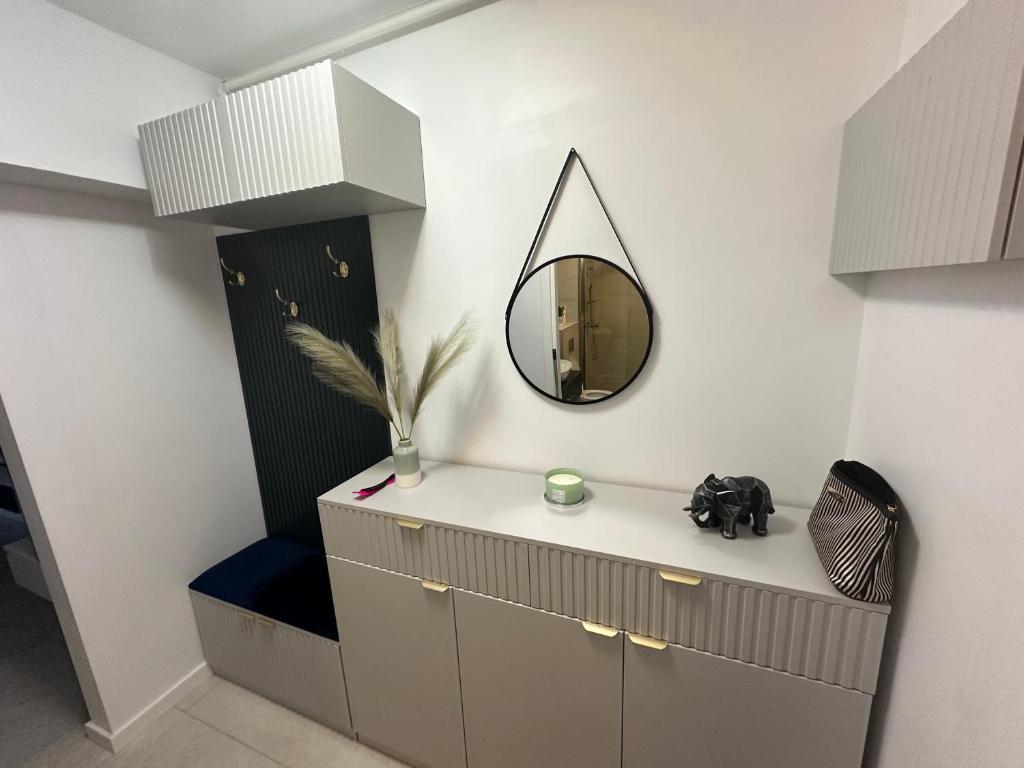 a bathroom with a mirror on the wall and a vanity at Studio Bianca in Eforie Nord