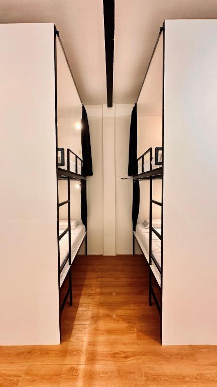 two bunk beds in a room with wooden floors at Puy-An, A Nomad Hostel in Moalboal